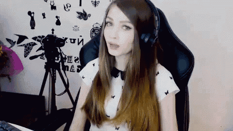 a woman wearing headphones is sitting in front of a camera ..
