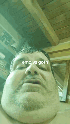 a close up of a man 's face with the words emo vs goth above him