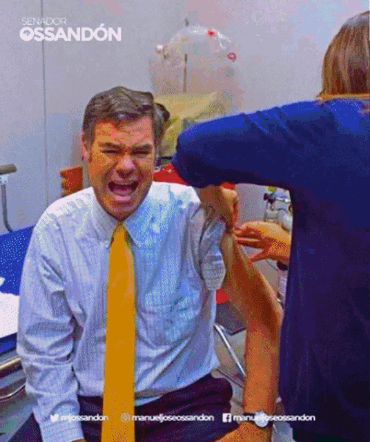 a man in a suit and tie is getting an injection from a woman with the name manuel jossandon on the bottom