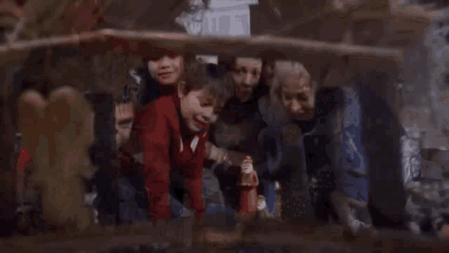 a group of children are looking at a nativity scene