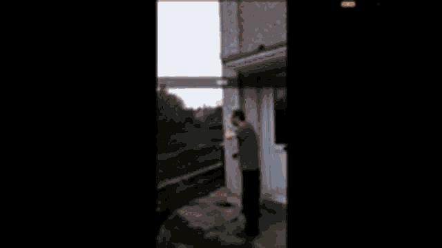 a man is standing in front of a door with a fireball in his hand ..