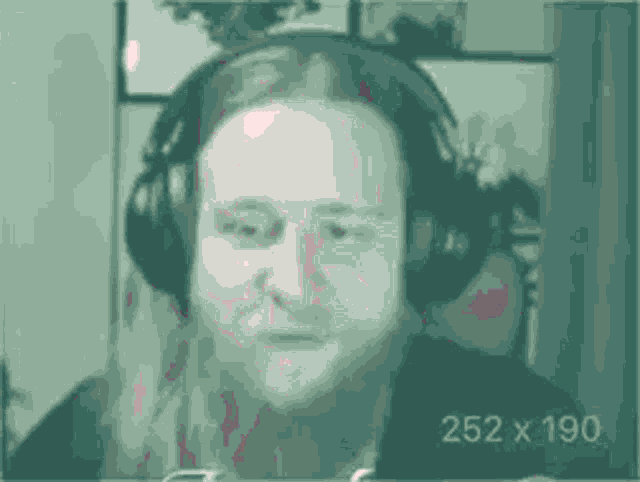 a man wearing headphones is making a funny face .