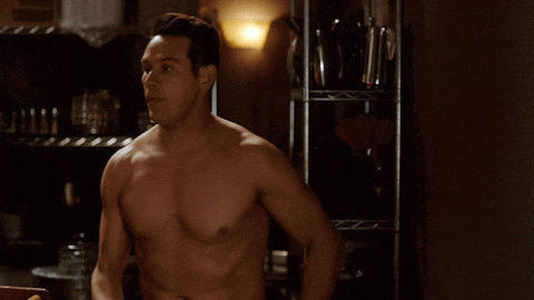 a man without a shirt is standing in front of a shelf that has a box on it that says " creamer "