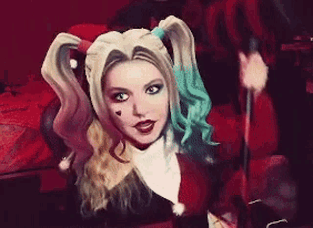 a girl in a harley quinn costume with pigtails