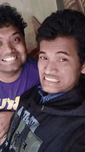 two young men are posing for a picture and one has a hoodie that says new york on it