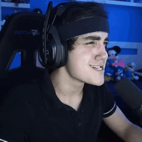 a man wearing headphones and a headband that says protom