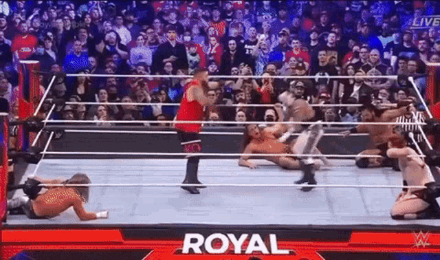 a group of men are wrestling in a wrestling ring with the word royal on the bottom .