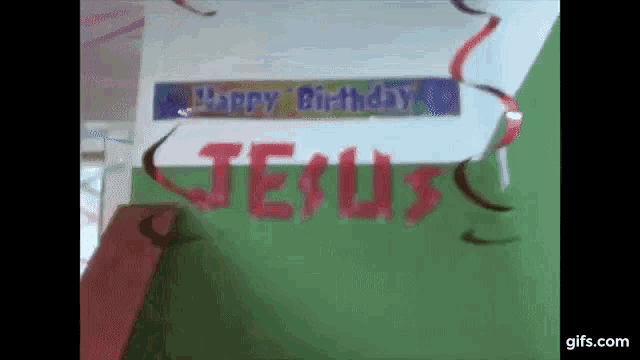 jesus is written in red on a green wall .