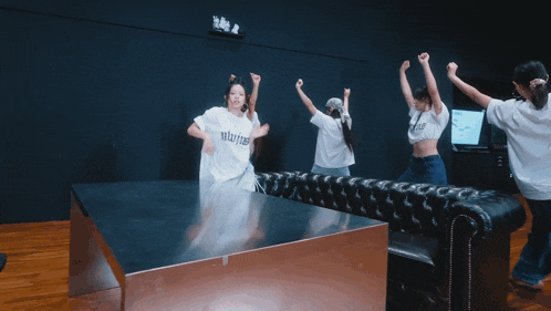 a group of girls are dancing in a room and one of the girls is wearing a white shirt that says " always "