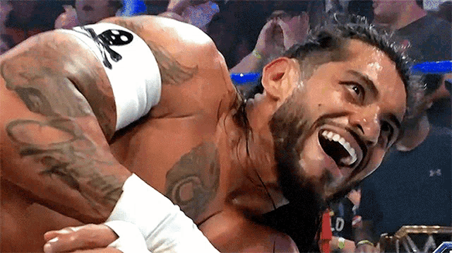 a wrestler with a tattoo on his arm that says ' captain ' on it