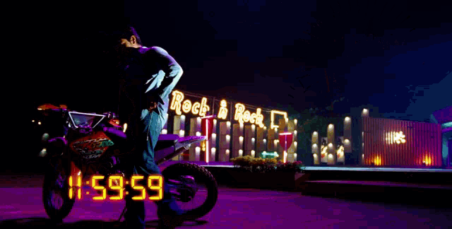 a man stands next to a motorcycle in front of a neon sign that says rock & rock