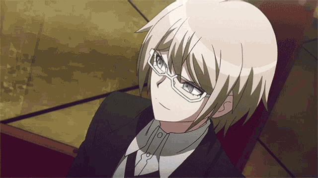 a close up of a person wearing glasses and a suit and tie