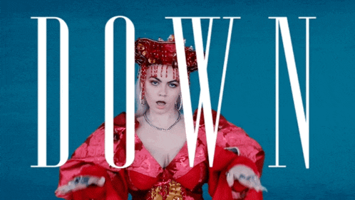 a woman in a red dress stands in front of the words down