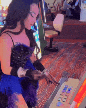 a woman in a blue dress is playing a game