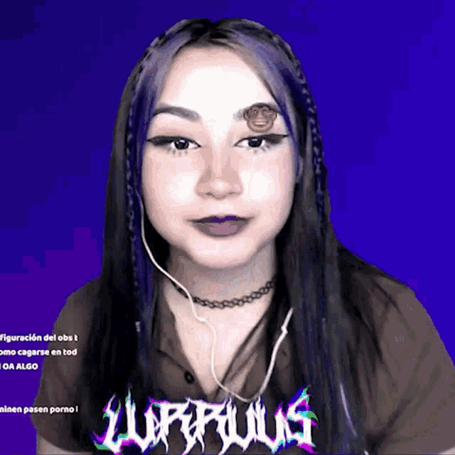 a girl with a tattoo of a monkey on her forehead is wearing a shirt that says lurfious