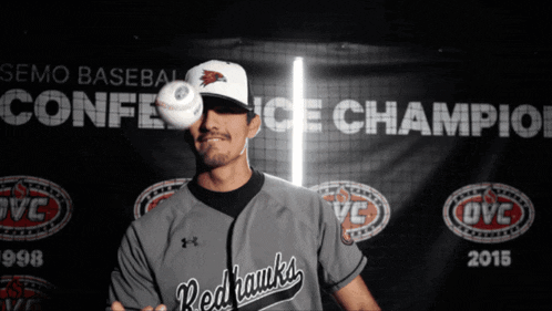 a man holding a baseball in front of a banner that says semo baseball conference champion 2015