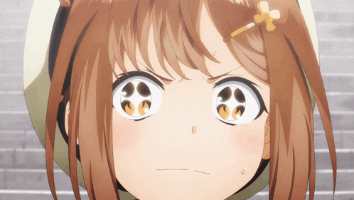a close up of a girl with a flower in her hair making an angry face