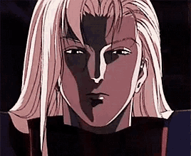 a close up of a man 's face with long blonde hair and a shadow on his face .