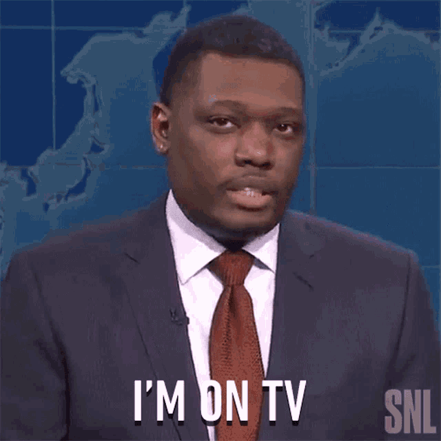 a man in a suit and tie is saying i 'm on tv .
