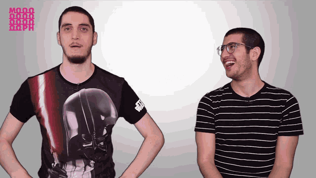 two men are standing next to each other and one of them is wearing a star wars shirt
