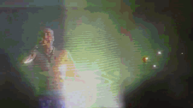 a blurred image of a man singing into a microphone with the word adidas on the bottom right