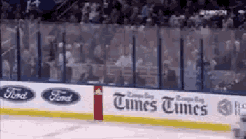 a hockey rink with a ford and times times ad on the ice .