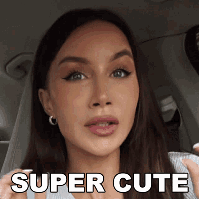 a woman in a car with the words super cute written on her face