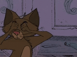 a cartoon cat with yellow eyes is sitting on the floor