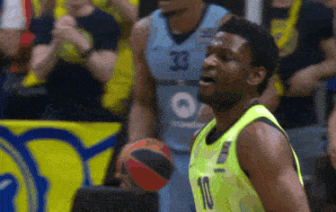 a basketball player with the number 10 on his jersey is holding a ball