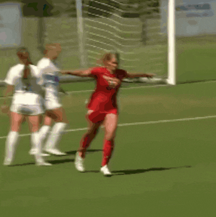a female soccer player wearing a red jersey with the number 23 on it