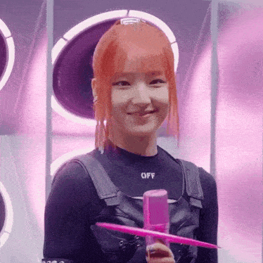 a girl with red hair is wearing a black top with the word off on it