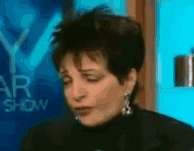 a blurry picture of a woman in front of a sign that says ' yv ' on it