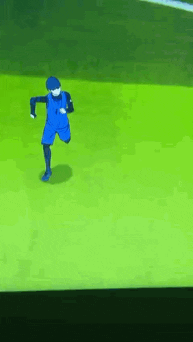 a soccer player in blue shorts is running on a green field