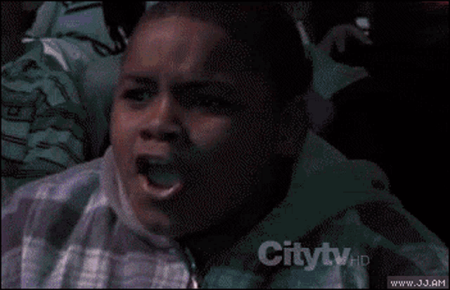 a young boy is making a funny face in front of a crowd and the words citytv are on the bottom right