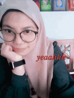 a woman wearing glasses and a hijab has the word yeahhh on her face