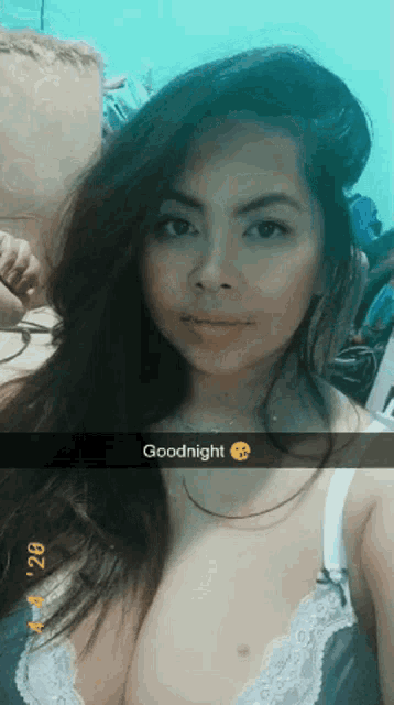 a woman in a bra is taking a selfie and says goodnight on the bottom