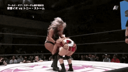 a woman is wrestling another woman in a ring .