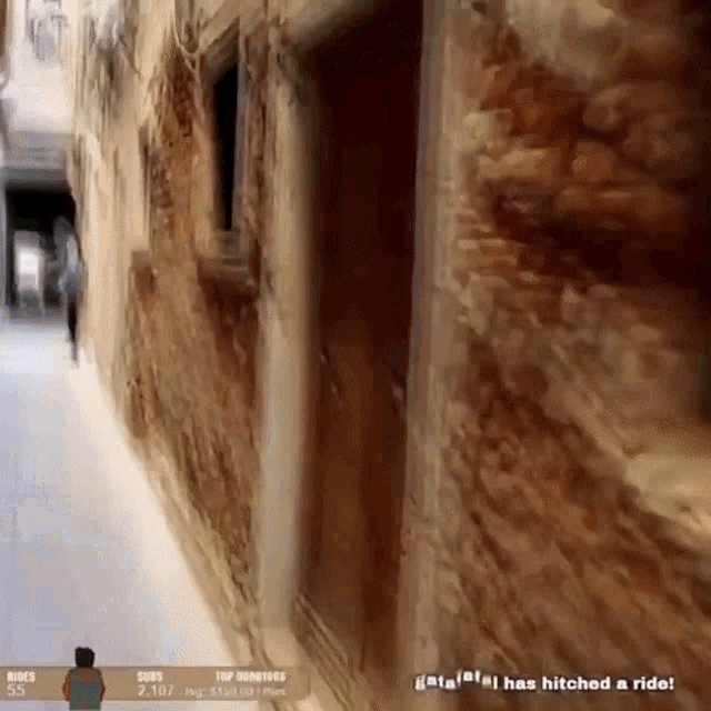 a video game screen shows a man walking down a narrow alleyway and says that he has hitched a ride