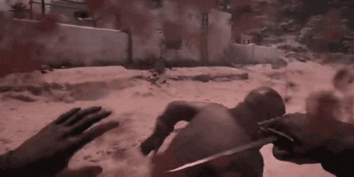 a person is holding a knife to a man 's back .