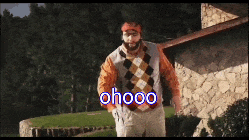 a man in an argyle sweater is standing in front of a stone building with the words ohooo written on the screen