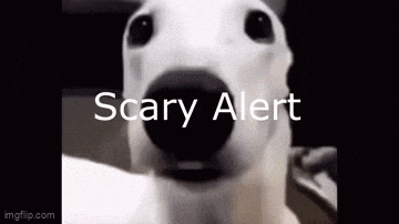 a white dog with a black nose is looking at the camera with the words `` scary alert '' written on it .