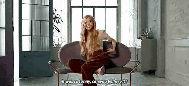 a woman is sitting on a couch in a living room and talking .