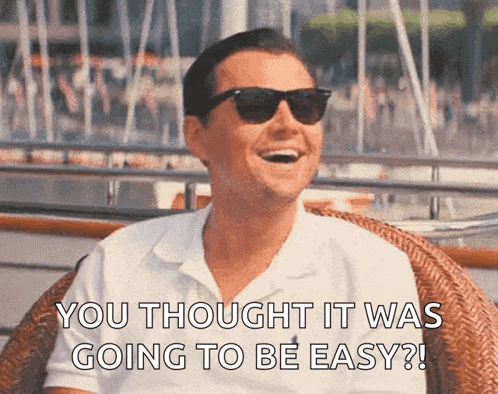 a man wearing sunglasses and a white shirt is laughing and saying you thought it was going to be easy