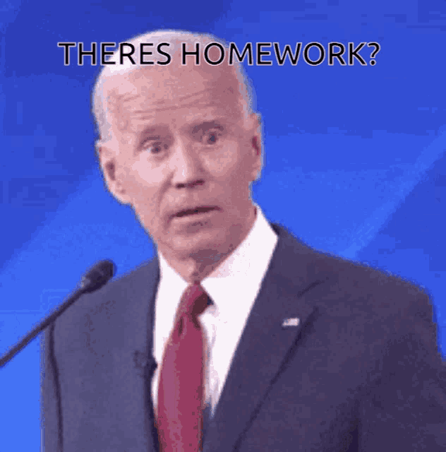 a man in a suit and tie stands in front of a microphone and says there is homework