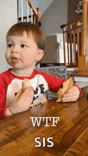 a little boy is sitting at a table eating a sandwich with the words wtf sis written on it