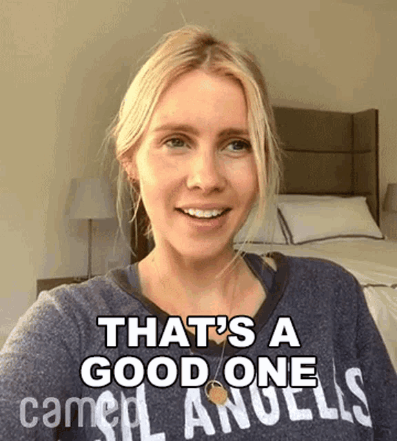 a woman wearing a grey shirt that says that 's a good one