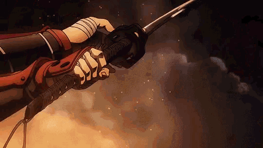 a close up of a person holding a sword in their hand .