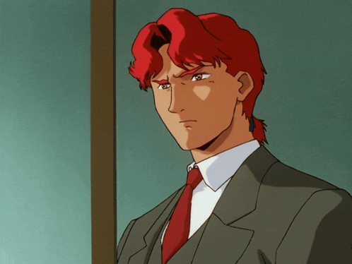 a man with red hair and a suit and tie