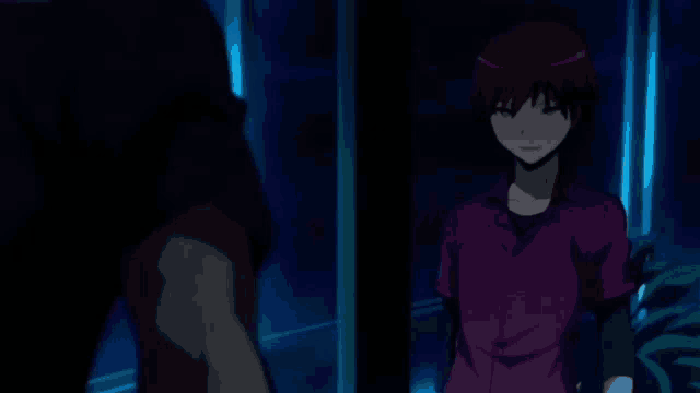 a man and a boy are standing next to each other in a dark room . the boy is wearing a purple shirt .