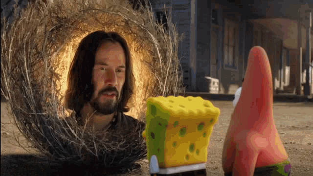 a man with a beard is standing next to a spongebob squarepants
